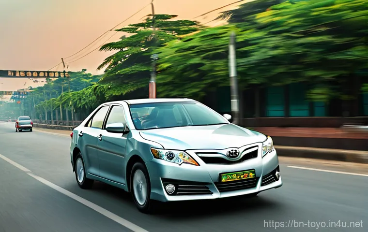 토요타 캠리의 중고차 시세 - **Prompt:** A well-maintained, mid-2010s (e.g., 2012-2015 model) Toyota Camry, gleaming faintly unde...