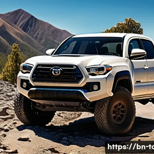 Home 31 토요타 타코마의 장기 시승기 - A rugged Toyota Tacoma pickup truck navigating a rocky, mountainous off-road trail in vibrant daylig...
