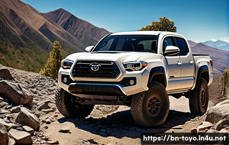 토요타 타코마의 장기 시승기 - A rugged Toyota Tacoma pickup truck navigating a rocky, mountainous off-road trail in vibrant daylig...